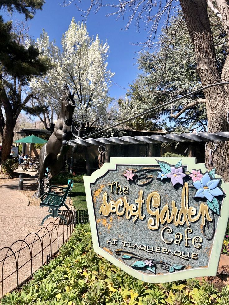 a sign for the lost garden cafe in an amusement park