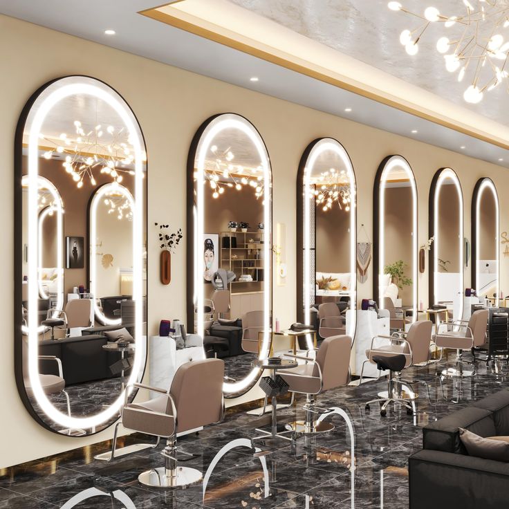 the interior of a salon with large mirrors and chairs in front of them, along with chandeliers hanging from the ceiling