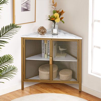 a white marble top cabinet with gold trimmings and two shelves on each side