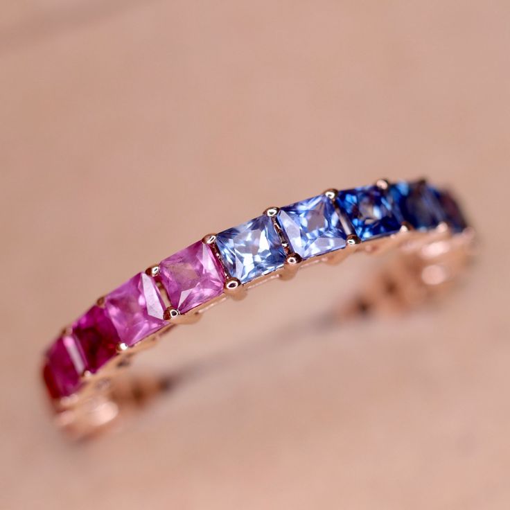 One of our highest selling product - Rainbow Natural Sapphire Eternity Band withcarefully selected Multi Color Princess Cut Sapphires. Made with Solid 14K or 18K Gold. ◆ Metals Details ◆ Metal: 14K & 18K Solid Gold Colors: White, Yellow & Rose Gold ◆ Stone Details ◆ Stone: Natural Sapphires Stone Size: 2.8mm Stone Shape: Princess Cut (Square) Design: Eternity Design ◆ Shipping Details ◆ Shipping: Via FedEx Express Processing Time: 5 to 10 Days Delivery: 5 to 7 Days Tracking ID provided ◆ Customi Rainbow Rings Jewelry, Elegant Multicolor Stackable Eternity Band, Luxury Multi-stone Eternity Band For Anniversary, Luxury Half Eternity Sapphire Ring Gift, Yellow Gold Multi-stone Eternity Band, Luxury Stackable Sapphire Ring For Anniversary, Luxury Stackable Sapphire Anniversary Ring, Elegant Multicolor Stackable Rings, Elegant Multicolor Eternity Band As Gift