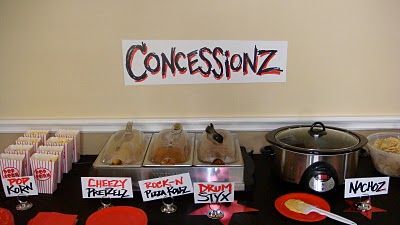 a table topped with lots of food and condiments next to a sign that says concessionz