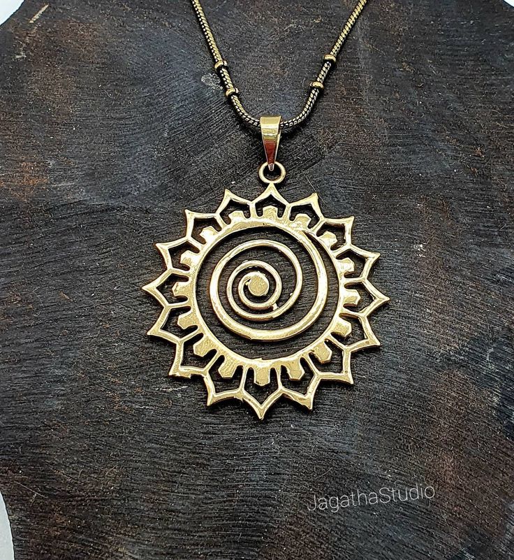 HANDMADE Stunning statement Star Mandala, sacred geometry pendant with a complementary chain. Made by hand with hight quality of brass, Nickel free.  SIZE Aprox pendant height: 5.5 cm Aprox Pendant Width: 4.4 cm LINK Don't miss the rest of the collection, please follow the link.  https://www.etsy.com/uk/shop/JagathaStudio Symbolic Brass Charm Necklaces With Adjustable Chain, Festival Brass Jewelry With Adjustable Chain, Symbolic Brass Pendant Charm Necklaces, Gold Spiritual Charm Necklace, Spiritual Metal Charm Necklaces, Symbolic Brass Necklace With Adjustable Chain, Spiritual Round Pendant Jewelry For Festival, Spiritual Brass Jewelry With Oxidized Finish, Spiritual Antique Gold Brass Jewelry