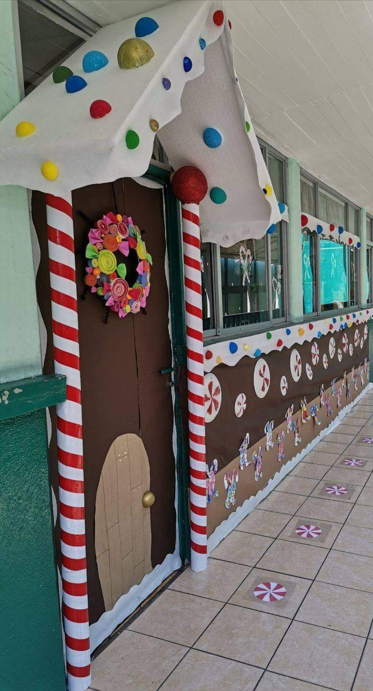 a decorated door with candy canes and decorations on the front entrance to a building