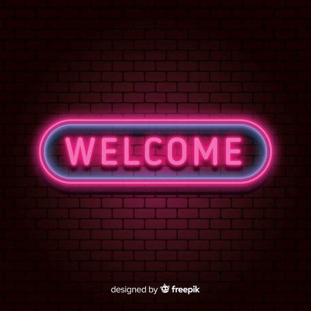 neon welcome sign with brick wall background