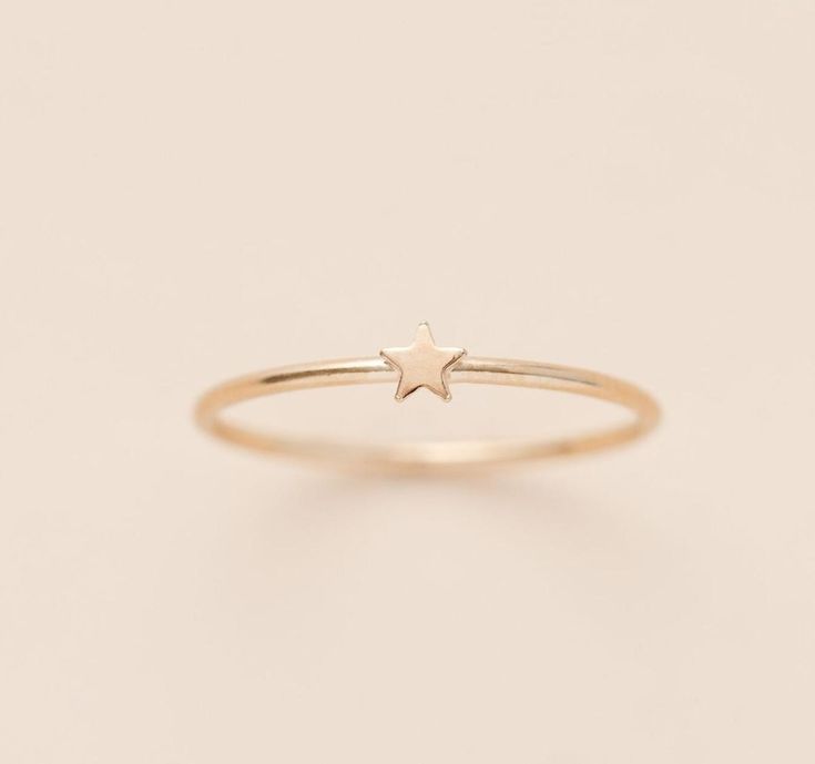 Because you deserve a GOLD STAR! This is a great texture piece.  It makes any stack more versatile and beautiful, and features the cutest dainty gold star. This dainty look will be great paired with a birthstone or other stacking rings.  Details: Location: Finger (order larger or smaller sizes depending on which finger you choose to wear it) Thickness: 3.5mm Sizes: 5,6,7,8,9 Style: Minimalist/Dainty Made with: 14K Gold Filled Why Gold Filled? Gold filled is a layer of 14K gold that has been pressure bonded to a brass base metal. Gold filled has 100 times more gold than gold plating and is much more valuable and tarnish resistant. It will not flake, rub off, or turn color. It can be worn without worries of an allergic reaction to the jewelry. Rings Minimalist, Dainty Rings, Twist Ring, Rings For Girls, Gold Star, Minimalist Rings, Dainty Ring, Stacking Ring, Stackable Rings