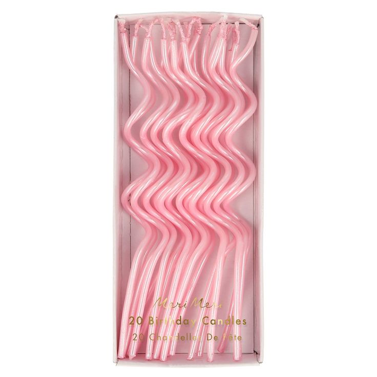 pink plastic straws in a box on a white background