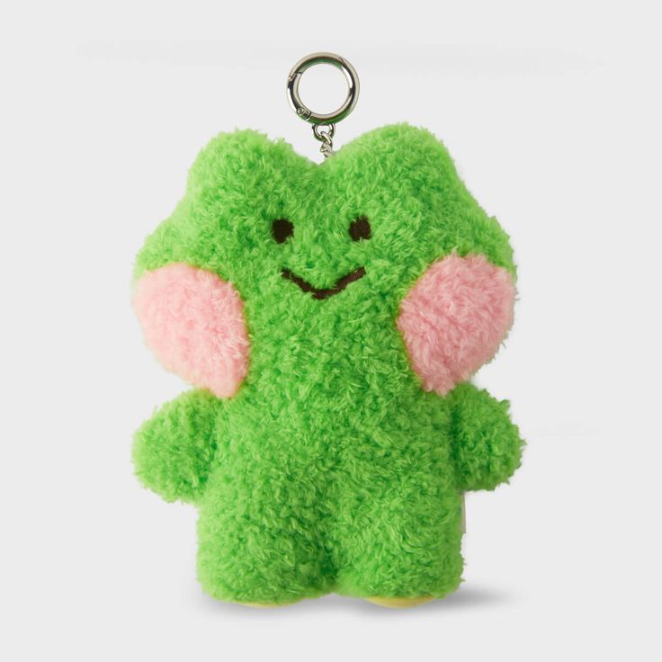 a green stuffed animal keychain with an elephant on it's face and ears