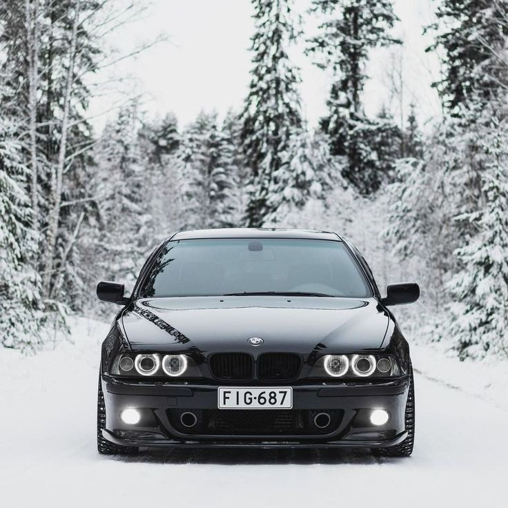 a black car is parked in the snow