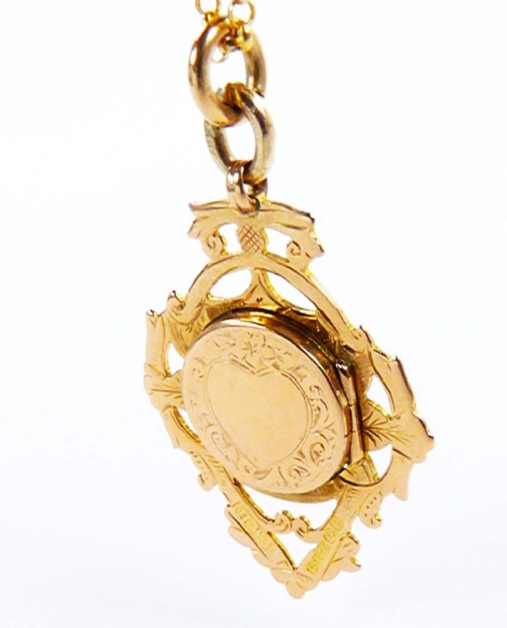 An outstanding fully hallmarked gold watch fob locket which is an ideal unisex gift, whether it is suspended from a fob chain or necklace. This antique keepsake fob locket was assayed* (tested for gold purity*) at Birmingham in 1907. The anterior surface is fitted with a locket compartment which is ornamented with a heart shaped cartouche framed by acanthus leaves and a single forget-me-not flower. This keepsake pendant is suspended from a beautiful 18 inch 9 carat gold belcher chain necklace. Victorian Yellow Gold Pocket Watch For Anniversary, Elegant Gold Hallmarked Pocket Watch, Elegant Gold Pocket Watch For Wedding, Heirloom Yellow Gold Pocket Watch As Gift, Heirloom Yellow Gold Pocket Watch For Anniversary, Heirloom Yellow Gold Medallion Pocket Watch, Antique Yellow Gold Pocket Watch With Locket, Classic Gold Hallmarked Pocket Watch, Gold Hallmarked Pocket Watch As Gift