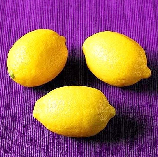 three lemons sitting on top of a purple cloth