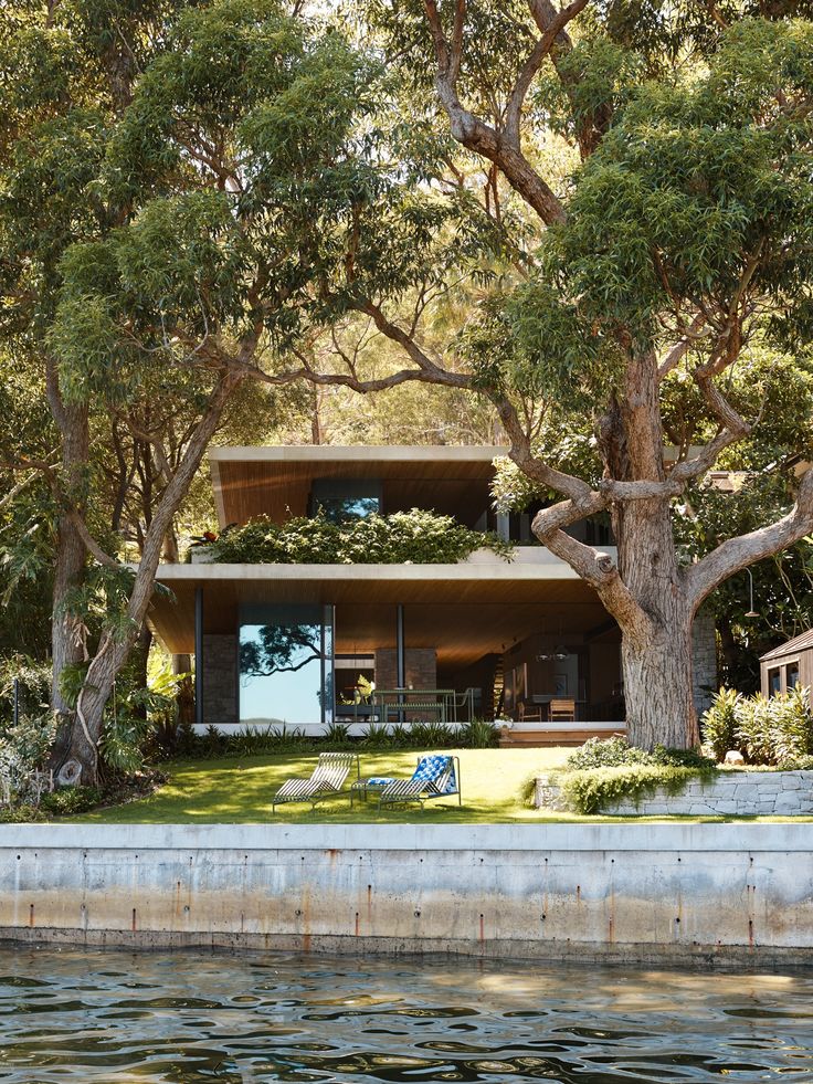 the house is surrounded by trees and water