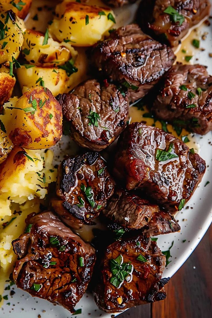 steak and potatoes on a white plate with garnished with fresh parmesan sprigs