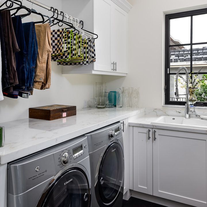 a washer and dryer in a white kitchen