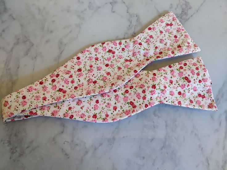 Upgrade your wardrobe in style with this stunning white and pink coloured floral bow tie. Perfect gift for him, this unique fully adjustable bow tie will elevate any occasion including weddings, birthdays and anniversaries. Made from cotton. Pink Floral Bow Tie, White Adjustable Bow With Butterfly Knot, White Summer Bow For Gifts, Pink Bow Gift For Spring, Spring Bow Tie As Gift, White Bow Tie Gift, White Bow Tie For Gifts, Fitted Bow For Spring Black Tie Events, White Adjustable Bow Tie Back