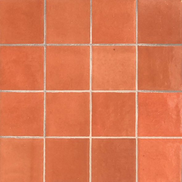 an orange tiled floor with white lines on it