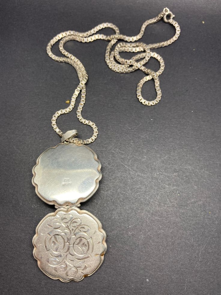 It is a English hallmarked, vintage, round, ornate, locket/pendant, with a silver chain, there is a silver hallmark on the clasp, weight 23 g, pendant height 4.2 cm, 3.2 cm diameter, chain is 55 cm long, in a good condition. Vintage Charm Medallion Necklace Amulet Style, Vintage Charm Medallion Amulet Necklace, Vintage Charm Medallion Necklace Styled As Amulet, Vintage Medallion Necklace With Amulet Style, Antique Medallion Jewelry With Coin Pendant, Victorian Style Medallion Coin Pendant Jewelry, Antique Coin Pendant Jewelry, Engraved Medallion Necklace, Antique Oval Coin Pendant Necklace