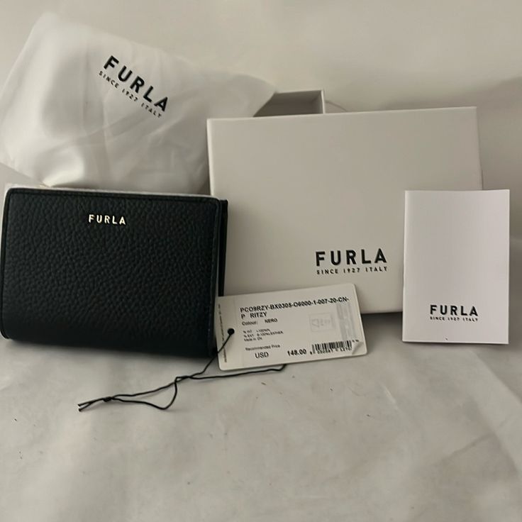 Nwt Authentic Furla Wallet In Black. 4 Slots For Credit Cards, A Zippered Coin Case & Slots For Paper Bills And 2 Larger Slots For Things Like Health Care Or Membership Cards. 4 3/4 In Across, 3 1/2 In Length, 3/4 Inches In Depth This Wallet Is Brand New And Perfect For Your Smaller Bags. Stylish, Pebbled Leather. This One Won't Last!! Ships With 1 Day! Includes Furla Branded Box & Dust Bag Smoke Free/Pet Free Home Black Trifold Wallet For Evening, Elegant Compact Trifold Wallet, Elegant Black Compact Trifold Wallet, Compact Black Trifold Wallet, Elegant Black Bifold Coin Purse, Elegant Black Trifold Wallet For Evening, Elegant Black Trifold Wallet, Elegant Black Trifold Evening Wallet, Formal Black Trifold Wallet