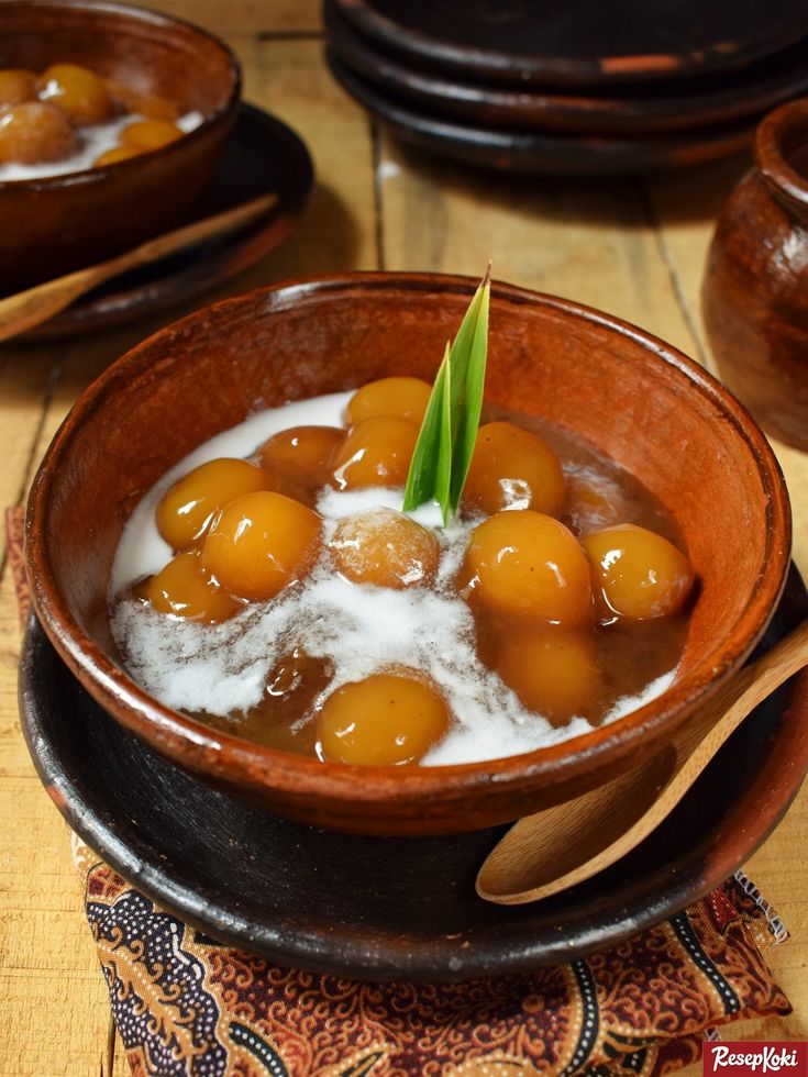 a wooden bowl filled with some kind of food