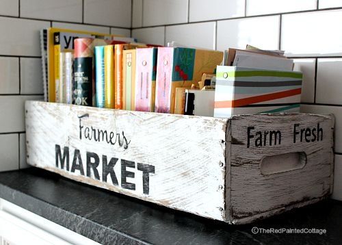 a wooden crate filled with books on top of a counter