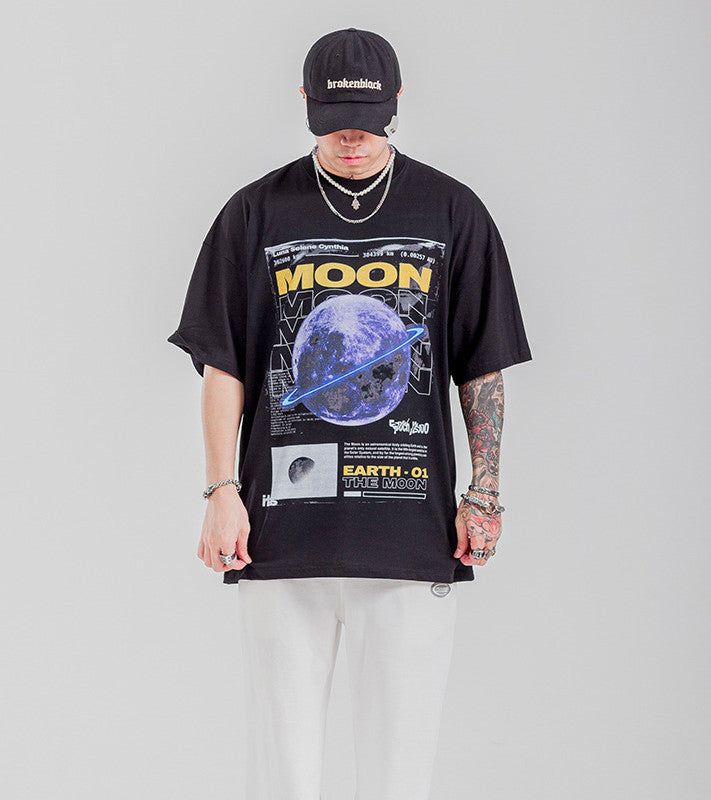 Reach for the stars with Speedy Apparel's "The Moon" Graphic T-Shirt. This shirt captures the mystery and beauty of the moon, blending cosmic inspiration with sleek, minimalist design. Perfect for those who love astronomy, space exploration, or simply admire the moon’s natural beauty, this tee is more than just clothing—it’s a statement of your connection to the universe. Why You’ll Love It: Stunning Moon Graphic: Features a detailed graphic of the moon, designed to inspire wonder and curiosity. Graphic Tee With Moon Print For Streetwear, Space-themed Graphic Print Cotton T-shirt, Space-themed Graphic Print Short Sleeve Tops, Space-themed Cotton T-shirt With Graphic Print, Space-themed Short Sleeve Top With Graphic Print, Short Sleeve Moon Print T-shirt For Streetwear, Space-themed Graphic Crew Neck Tops, Black Graphic Tee With Moon Print, Black Moon Print Graphic Tee