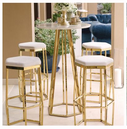 three stools and a table in a room