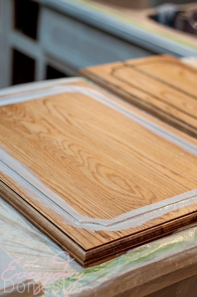 two wooden boards sitting on top of a table next to each other in front of a stove