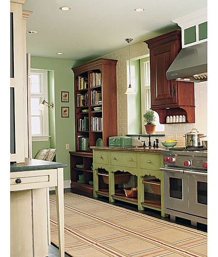 a kitchen with an oven, stove and bookcases on the wall in front of it