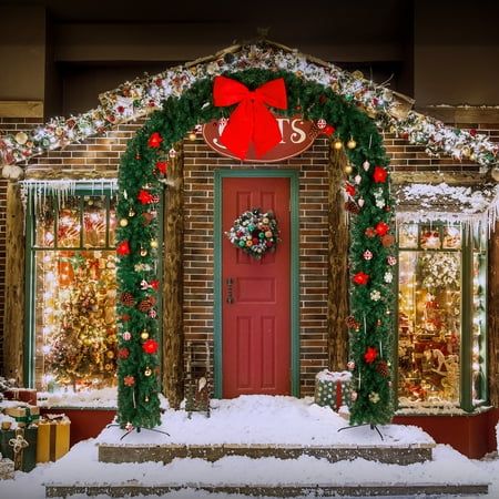 a red front door covered in christmas decorations