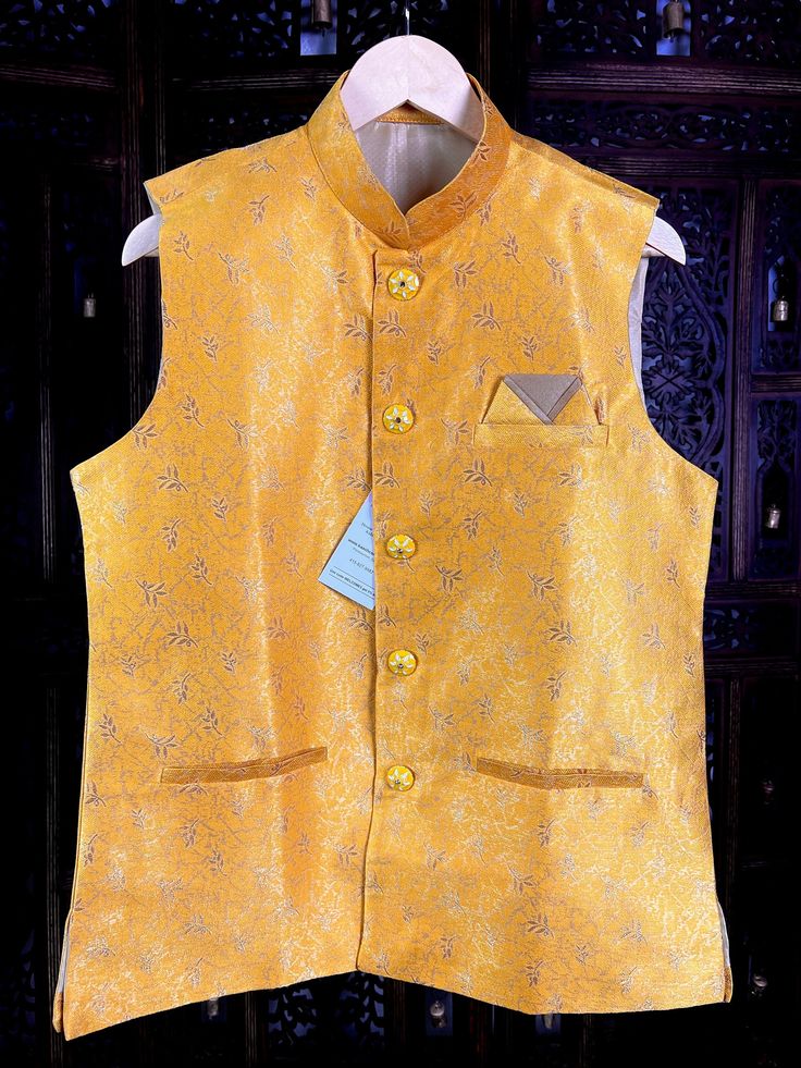 Premium quality Silk Men's Waist Coat in Yellow Color gorgeous Zari Weaving Floral designs. Can be paired with a Kurta Pajama Set. Item : Men's Jacket Ready to Wear : Yes Jacket Color : Mango Yellow Fabric : Raw Silk Work : Fancy buttons, Self Deign Pattern Material Pattern : Designer Lining : Yes Measurements of the Jacket Size - 38 Chest : 40 inches Length : 27 inches Size - 40 Chest : 42 inches Length : 27 inches Size - 42 Chest : 43 inches Length : 27 1/2 inches Size - 44 Chest : 44 inches L Gold Fitted Nehru Jacket For Ceremonial Occasions, Gold Fitted Nehru Jacket For Groom, Gold Nehru Jacket For Groom, Festive Occasion, Yellow Nehru Jacket For Wedding And Festivals, Fitted Yellow Nehru Jacket For Festive Occasions, Fitted Yellow Nehru Jacket For Festivals, Fitted Yellow Nehru Jacket For Festive Season, Gold Fitted Nehru Jacket For Wedding, Festive Fitted Yellow Nehru Jacket