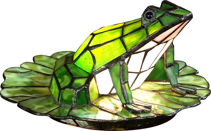 A handsome prince in disguise, the frog in the fanciful Odette Grove lamp is so life like he appears to be ready to leap off his lily pad and into a pond. Art glass in various shades of green, white and yellow make up this three dimensional frog sitting on a glass lily pad base. Whether you are a princess at heart or just looking to add a whimsical touch to your home, this delightful little accent lamp is for you. Partial assembly may be required. Stained Glass Frog, Frog Lily Pad, Tiffany Art, Glass Frog, Tiffany Lamps, Arte Inspo, Antique Lamps, Tiffany Style, Accent Lamp