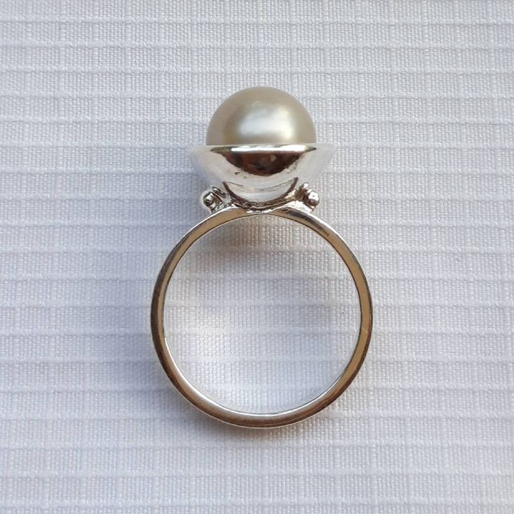 Minimalist South Sea Pearl engagement ring in silver tones Sterling silver pearl ring A romantic gift for engagement, anniversary and birthday Handmade and designed by Barock Pearl Pearl: shape round, color silver, size 9 mm South Sea Pearl cultured/grown at Lombok Island, Indonesia Ring size: please select the size from the chart For orders more than 250 $ US FREE SHIPPING. Shipping with EMS Parcel, approx. 10 to 15 working days. Don't forget to leave your phone number to complete the address Modern Sterling Silver Dome Ring For Wedding, Silver Sterling Pearl Ring, Sterling Silver Pearl Drop Ring For Promise Occasions, Sterling Silver Pearl Drop Ring For Promise, White Open Dome Ring For Wedding, Elegant Sterling Silver Dome Ring Gift, Minimalist Pearl Drop Rings As Gift, Minimalist Pearl Rings As A Gift, White Dome Wedding Ring With Open Shape