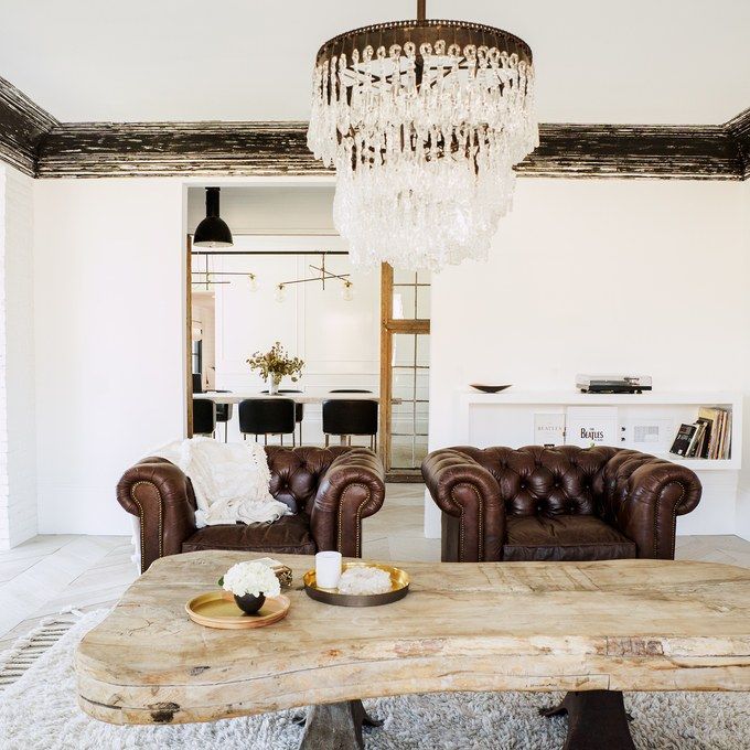 a living room with two couches and a table in the middle of the room