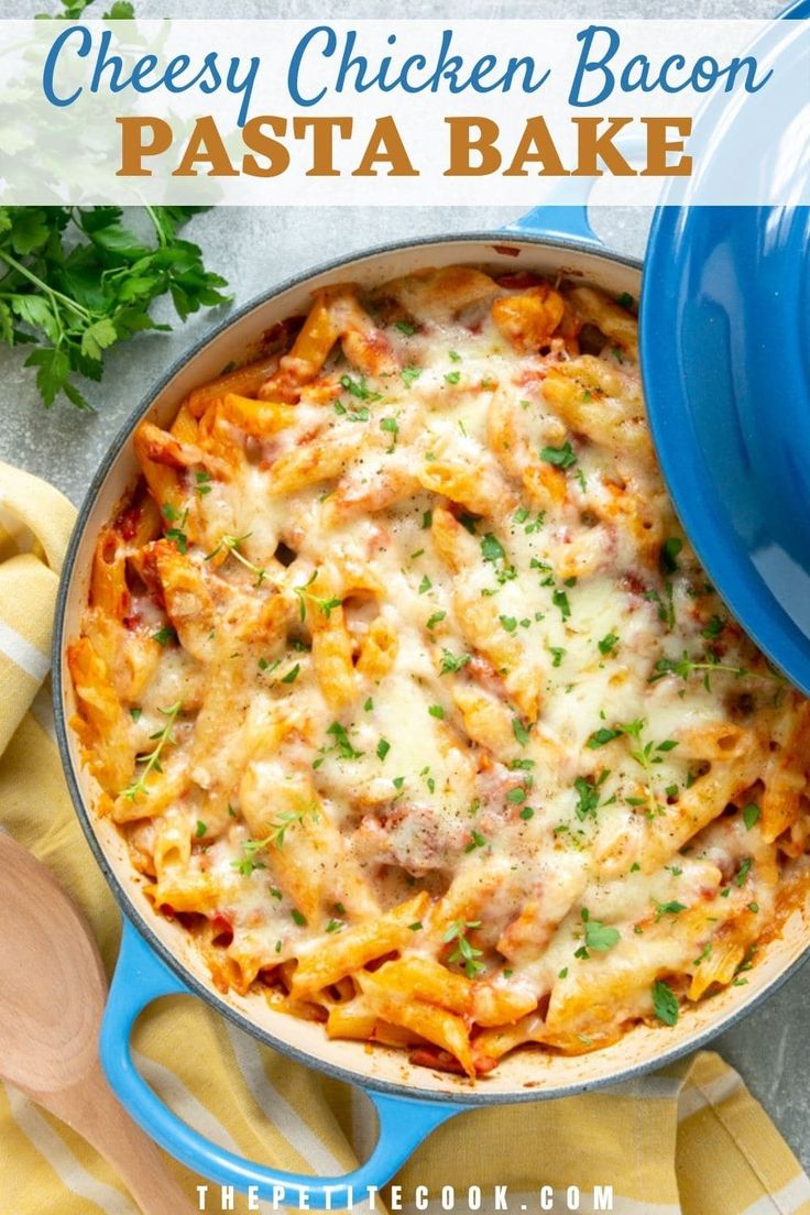 cheesy chicken bacon pasta bake in a blue casserole dish with parsley on the side