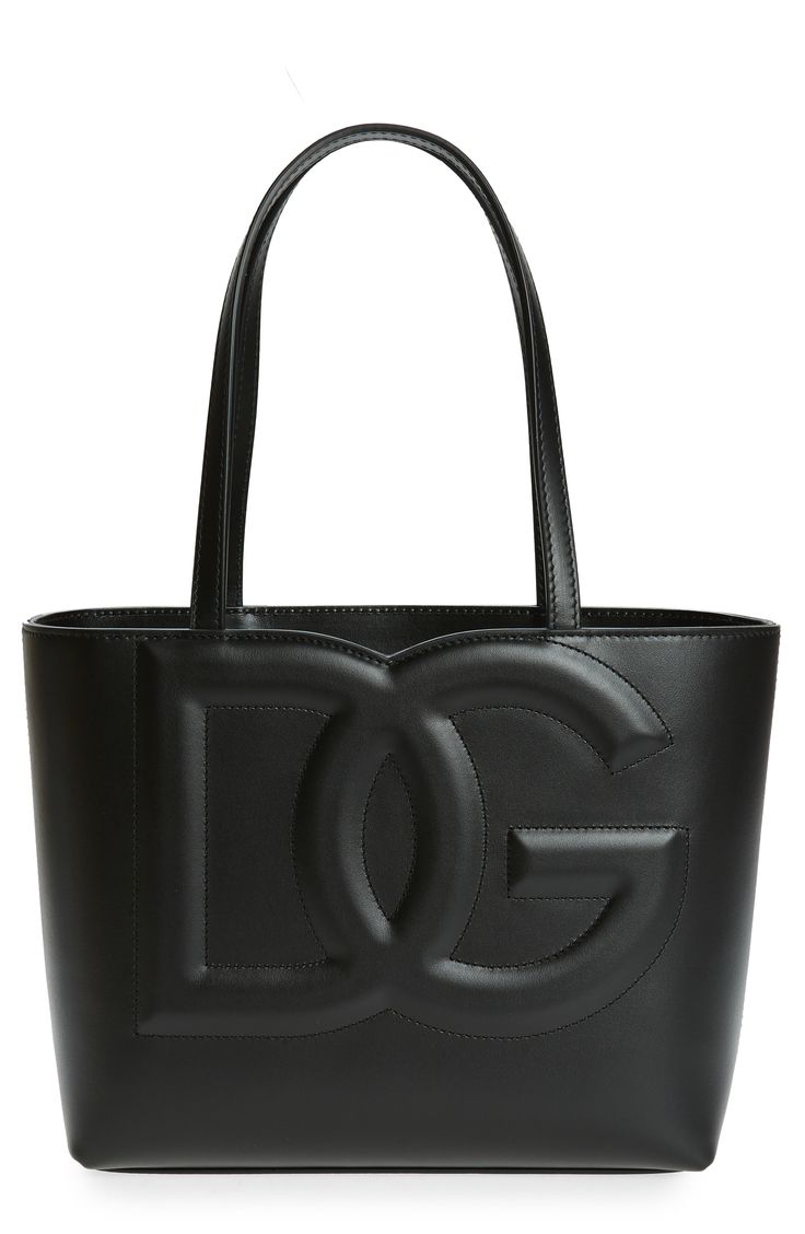 A subdued take on logomania, this calfskin-leather tote features a padded DG monogram that takes up the front and was created using a high-frequency technique. Open top Top carry handles Interior zip pocket Leather Made in Italy Designer Handbags Dg Monogram, Canvas Leather Tote, Dg Logo, Celine Luggage Bag, Top Top, Wallet Chain, Open Top, Canvas Leather, Designer Handbags