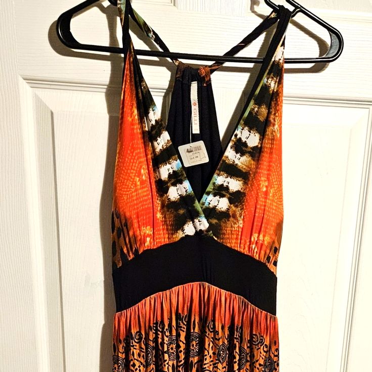 The Dress For Sale Is A Women's Long Hippie Boho Style Dress That Sleeveless. The Colors Are Orange Green Brown And Black. Brand New With Tags. The Brand Is Gilli. It Has Built-In Cups In The Chest Area. Summer Sleeveless Lined Maxi Dress, Sleeveless Lined Maxi Dress For Vacation, Orange Sleeveless Vacation Halter Dress, Sleeveless Orange Maxi Dress For Beach, Orange Sleeveless Halter Dress For Vacation, Sleeveless Orange Halter Dress For Vacation, Lined Sleeveless Halter Dress For Beach, Fitted Sleeveless Orange Sundress, Bohemian Sleeveless Lined Sundress