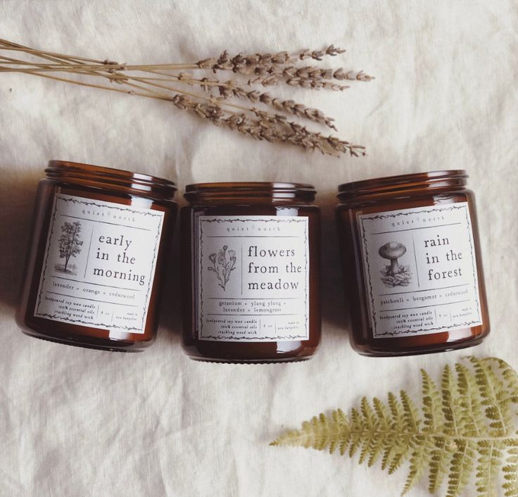 three jars of honey sitting on top of a table