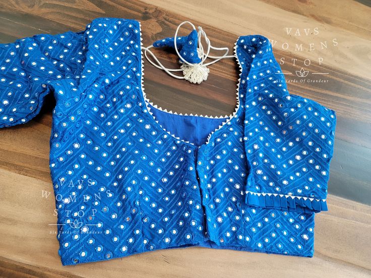 Blouse stitched - Yes Blouse Opening - Back Sleeves Length - Elbow Padded - No Blouse size - 34 with inner margins expandable upto 40 For Blouse Size 32 alteration can be done on request. Fitted Blue Tops With Mirror Work, Blue Bollywood Blouse With Mirror Work, Fitted Designer Blouse With Mirror Work, Designer Blue Tops With Mirror Work, Navratri Designer Chikankari Blouse, Blue Tops With Mirror Work, Long Sleeve Blouse With Mirror Work For Navratri, Traditional Blue Blouse With Mirror Work, Festive Cotton Blouse With Mirror Work