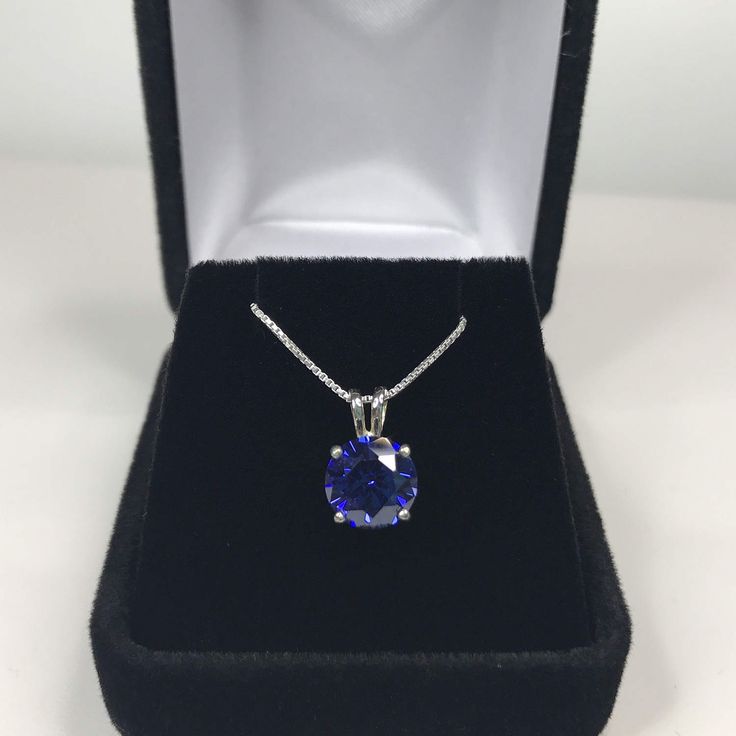 "Beautiful Brilliant Tanzanite* & Sterling Silver Pendant Necklace * 1.7ct Brilliant Cut Tanzanite* measures 8mm Round * Solid Sterling Silver * 16\" - 24\" Sterling Silver Chain included (select your length) Hallmarked & Gift Ready! *Tanzanite is one of very few gemstones that cannot be grown in a Lab, however, these Laboratory Grown Simulate Stones are optically identical to a natural Tanzanite in color and are just as hard but, do not have the same Chemistry or Composition as Tanzanit Tanzanite Pendant, White Gold Pendant Necklace, Trending Jewelry, White Gold Pendant, Fine Art Jewelry, Natural Tanzanite, Sterling Silver Necklace Pendants, Gold Pendant Necklace, Silver Pendant Necklace