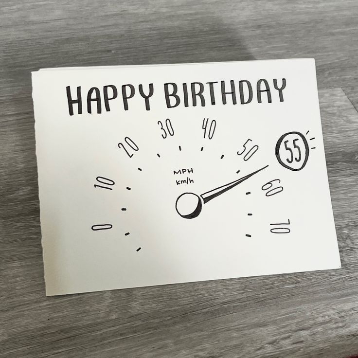 a happy birthday card with a speedometer on the front, and an hour handwritten in black ink