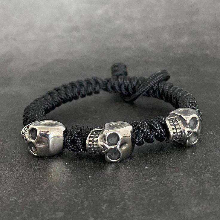 Each paracord bracelet features 3 stainless steel skull beads and is fully adjustable. It is perfect to add to a bracelet stack. The primary colour selection will be the main colour of the bracelet. The secondary colour is the micro cord which is woven over the end to secure the bracelet. For wrist size please measure your wrist with a tape measure and do not allow any slack or gaps in the tape. Please then select this as the size option. For other customised orders please do get in touch. Gothic Adjustable Bracelet For Streetwear, Adjustable Skull Wristband Gift, Adjustable Gothic Bracelet For Streetwear, Adjustable Silver Bracelet For Streetwear, Gothic Silver Adjustable Wristband, Gothic Style Adjustable Silver Wristband, Gothic Adjustable Silver Wristband, Silver Gothic Adjustable Wristband, Adjustable Gothic Skull Bracelets