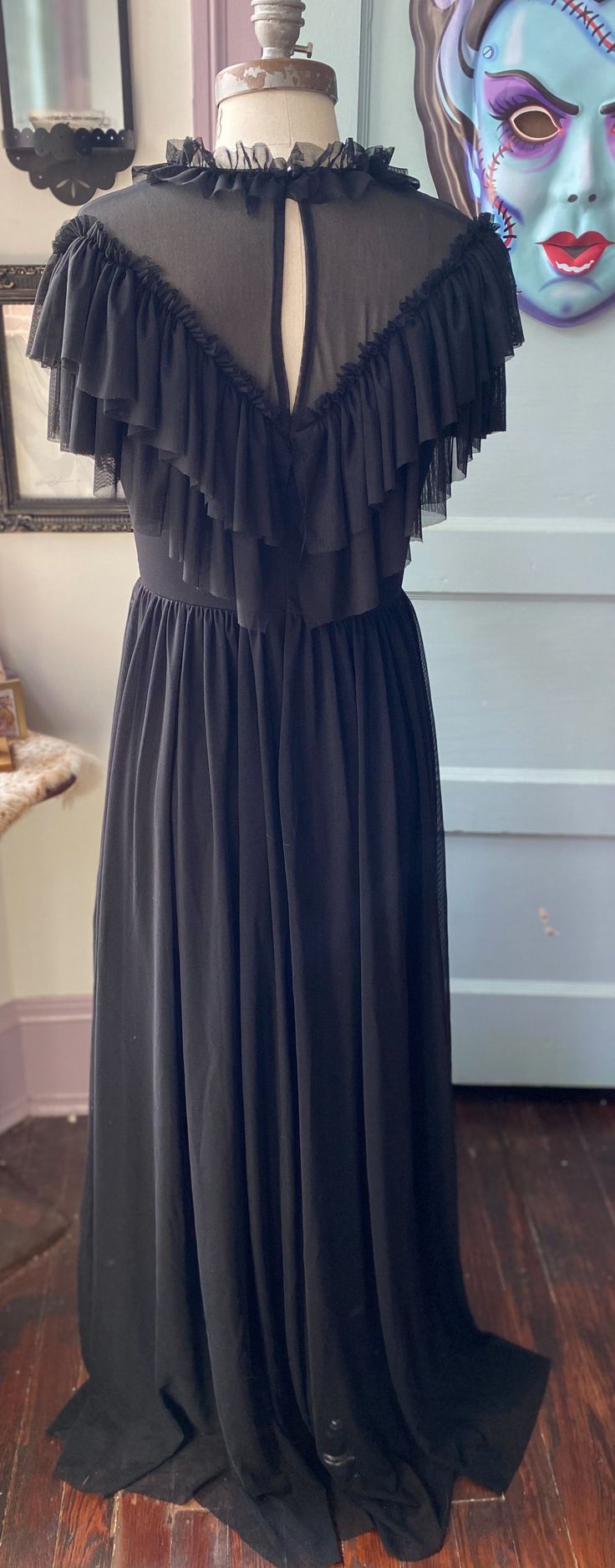 Meet Mina! The most romantic and dramatic Victorian gothic dress of your dreams! This dress is made out of over 5 yards of soft, buttery mesh, with a double layer ruffled neckline and a deep, plunging v neck at the front at the back. The back neck also has a keyhole cutout with a dainty button, and this entire dress is Ruffled V-neck Maxi Dress For Gala, Flowy Tiered Ruffle Dress For Evening, Flowy Evening Dress With Ruffled Straps, Flowy Ruffled Evening Dress, Black Maxi Dress With Ruffled Straps, Evening Dresses With Ruffles And Empire Waist, Empire Waist Ruffle Evening Dress, Evening Ruffle Dress With Ruffled Straps, Flowy Ruffled Dress For Evening