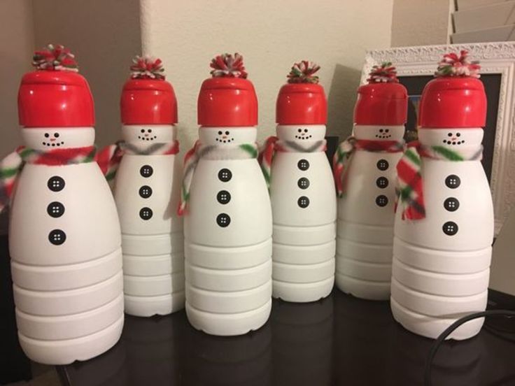 six snowmen are lined up in the shape of bowling pins