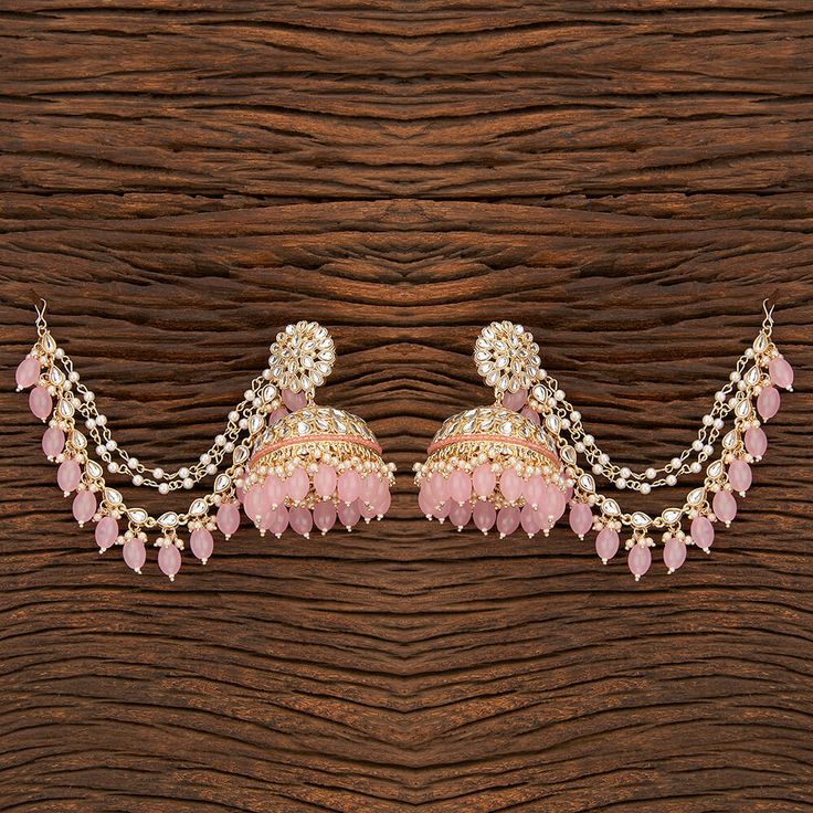 Add a regal look to your outfits with our Red Pankhuri Earrings. These Gold-Plated beauties feature Kundan with Red beads and a stunning Kaan chain design. Specifications Materials used: Kundan, Red beads Length: 7.5 cm, Width: 6 cm Weight: 8.1 grams At Romikas, we pride ourselves on the craftsmanship and high quality of our jewelry, designed to enhance your natural beauty. Please contact us with any questions. Fusion Kundan Jhumkas With Gota Work, Fusion Style Kundan Jhumkas With Gota Work, Fusion Chandbali Jhumkas With Gota Work, Fusion Style Chandbalis With Gota Work For Diwali, Elegant Danglers With Gota Work For Diwali Reception, Diwali Reception Danglers With Gota Work, Fusion Style Festive Jhumkas With Gota Work, Festive Fusion Jhumkas With Gota Work, Fusion Style Jhumkas With Gota Work For Festivals