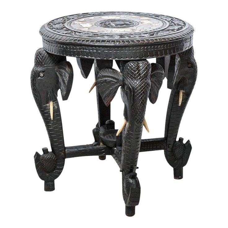 an elephant themed side table with two elephants on it's legs and one is painted black