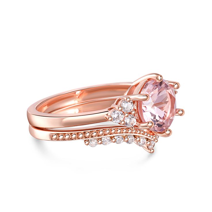 This exquisite ring set captures the essence of timeless elegance with its classic design. The main stone, a perfectly round morganite, takes center stage, radiating a soft and captivating blush hue. Flanking either side are three dazzling white gemstones, delicately set to enhance the brilliance of the centerpiece. The harmonious combination of the morganite and the sparkling white stones creates a mesmerizing display of light and color. Completing the set is a perfectly matched band, designed to complement the beauty of the main ring. Its intricate detailing and graceful curves add a touch of sophistication, enhancing the overall allure of this vintage-inspired masterpiece. With its nostalgic charm and impeccable craftsmanship, this morganite bridal set is a symbol of enduring love and t Elegant Pink Gold Jewelry With Center Stone, Elegant Pink Birthstone Ring For Promise, Classic Pink Jewelry For Promise, Elegant Pink Birthstone Promise Ring, Classic Pink Gold Ring With Round Cut, Elegant Morganite Jewelry With Accent Stones, Elegant Round Birthstone Ring With Vs Clarity, Elegant Stackable Rings With Accent Stones And Cubic Zirconia, Elegant Pink Ring For Anniversary