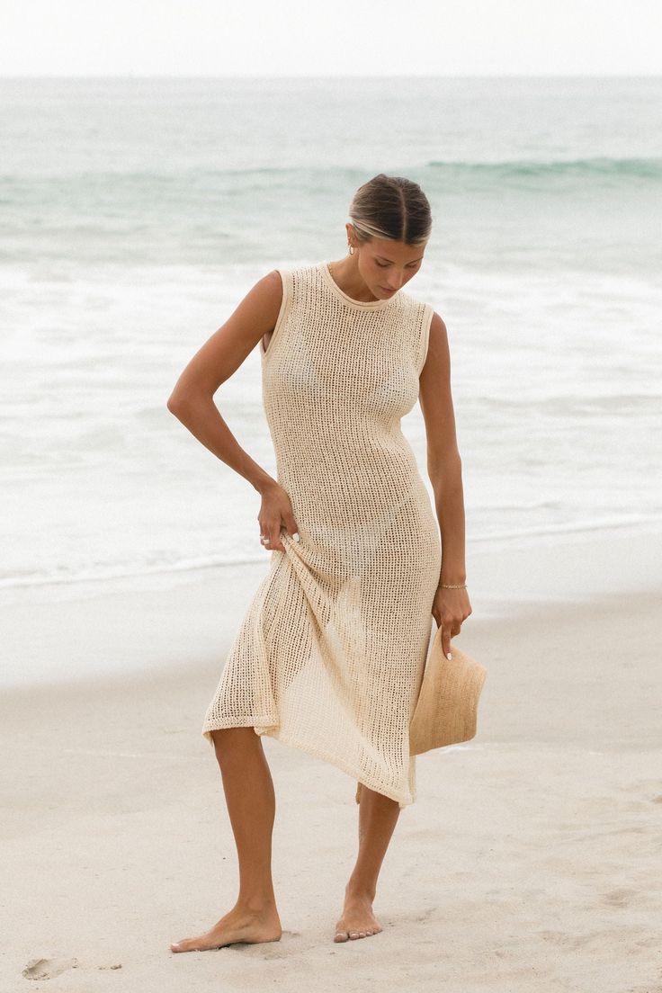 The Dolce Vita Cotton Knit Dress features an open knit design. Wear it over a swimsuit at the beach or pool as a cover-up. Made with soft cotton material for a breathable and lightweight feel. Knit Resort Wear, Summer Beige Knit Cover-up, Chic Beach Season Cover-up For Warm Weather, Chic Open Knit Dress For Beach Cover-up, Stretch Knitted Dresses For Vacation, Knitted Stretch Dress For Vacation, Beige Stretch Dress For Beach Season, Summer Knit Stretch Dress, Stretch Beige Dress For Beach Season