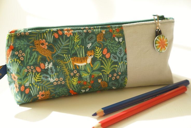 Pencil case /Pencil bag/ Pencil pouch / makeup bag / cosmetic bag/ zipper pull/sewing bag/tropical This is a lovely zipper pencil case for your children or yourself.  It could also be used to carry your cosmetics or sewing kit. These pencil cases are a hit at my children's school! Size: Length 22 cm; height 10 cm; width at base 5.5 cm 20 cm zipper. Materials: Exterior: a combination of beige linen and a lovely cotton fabric featuring a tropical forrest with birds, flowers; tigers and leopards on Green Zipper Pouch Pencil Case For School, Green Zipper Pencil Case For School, Green Pencil Case Pouch With Pen Holders, Green Pencil Shaped Case With Zipper Closure, Green Pencil Case Pouch For Daily Use, Green Pencil Case With Pen Slots For Daily Use, Green Pouch Pencil Case For Daily Use, Green Zipper Pouch For School, Green Pouch Pencil Case With Zipper