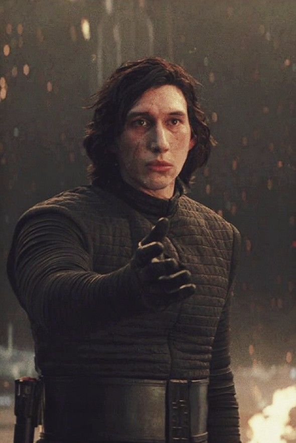 a man in a star wars outfit is holding his hand out to the side with fire coming from behind him