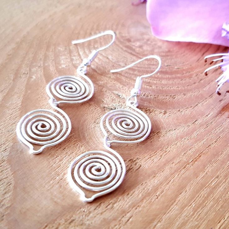 Double Silver Spiral Earrings A great Christmas or birthday gift idea, for someone who loves dangly earrings! ~ These wire wrapped dangle drop earrings have two silver leaf spirals. ~ Simple unique dainty earrings, perfect for any occasion, wear it with jeans and t-shirt or a formal frock. 💙 Made in a choice of silver, use the finish option box to choose from silver plated, 925 sterling silver or 99.99% fine silver (a certificate of authentication will be provided). 💝 GIFTS We can ship our pro Spiral Earrings With Ear Wire As Gift, Spiral Earrings With Ear Wire For Gifts, Spiral Silver-plated Wire Earrings, Silver Spiral Wire Wrapped Earrings, Spiral Wire Wrapped Silver-plated Earrings, Wire Wrapped Spiral Earrings In Silver Plated Wire, Spiral Silver Plated Wire Earrings For Gift, Spiral Silver Plated Wire Earrings As Gift, Spiral Wire Wrapped Silver Plated Earrings