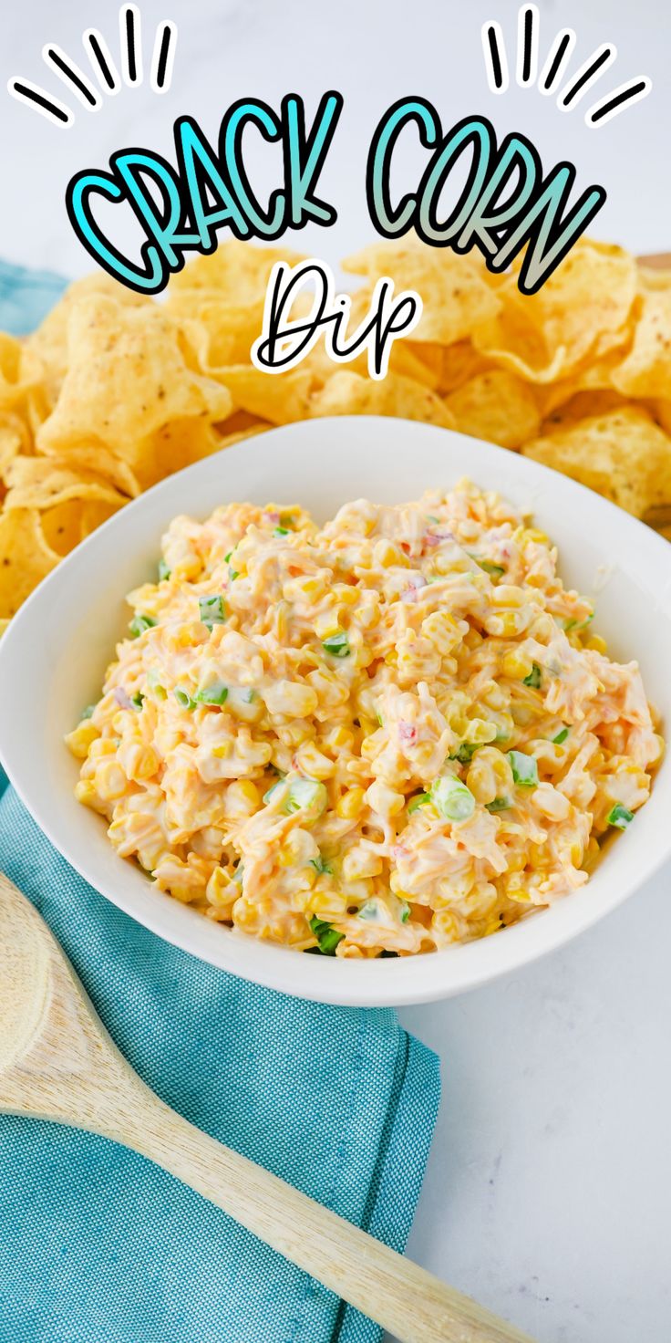 a white bowl filled with corn salad next to chips